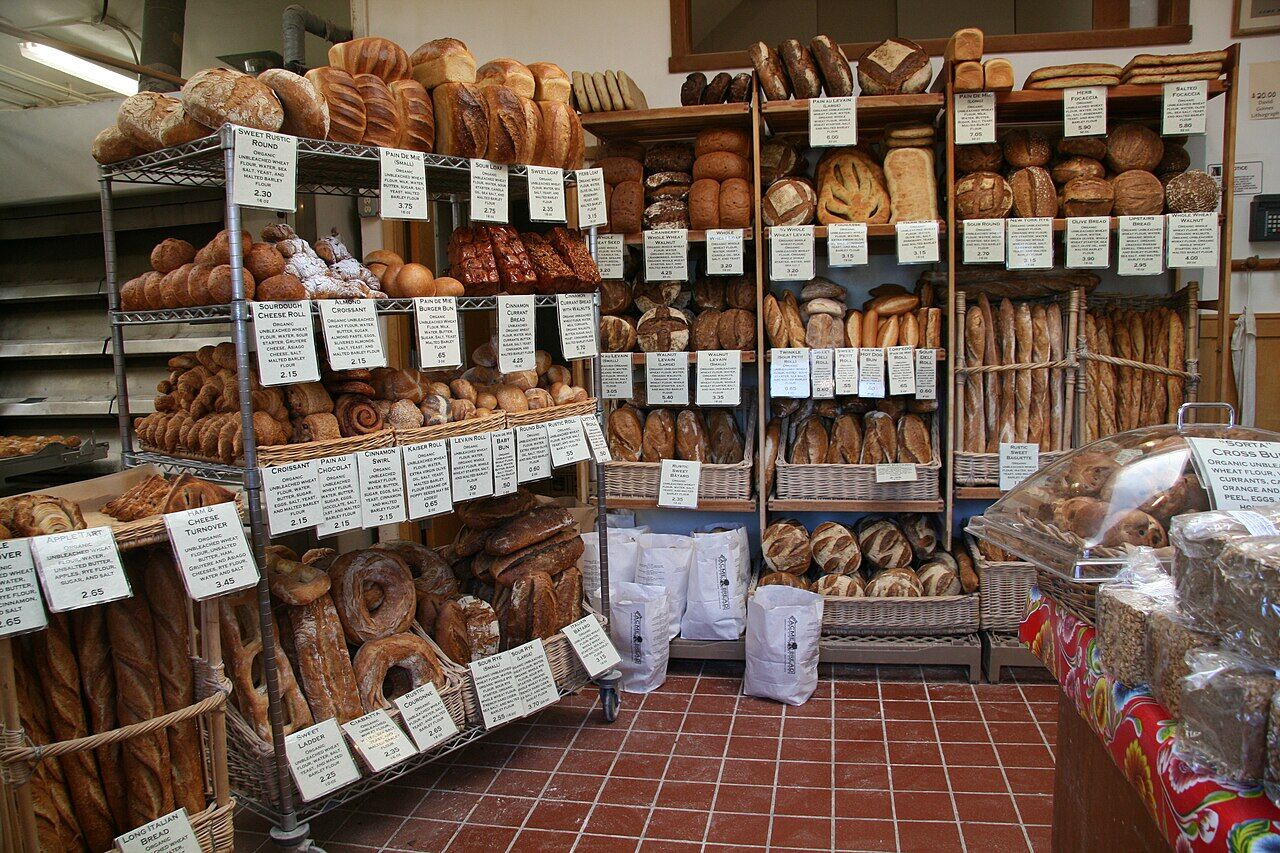 Interior display of Acme Bread shop with loaves on shelves
